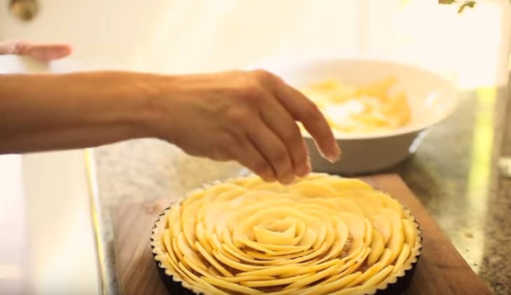 Adding sugar to a French Apple Tart ready for the oven