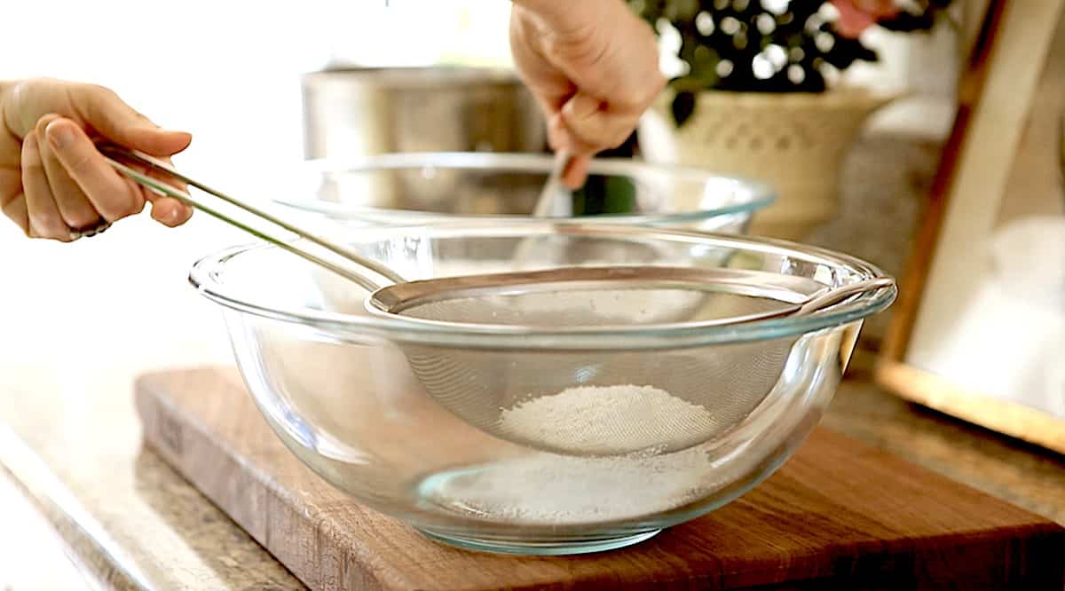 sifting dry ingredients in a fine mesh sieve