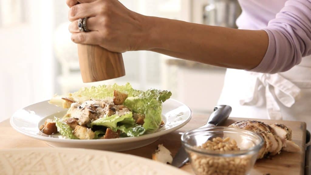 Cracked Pepper being added to an Easy Chicken Caesar Salad Recipe