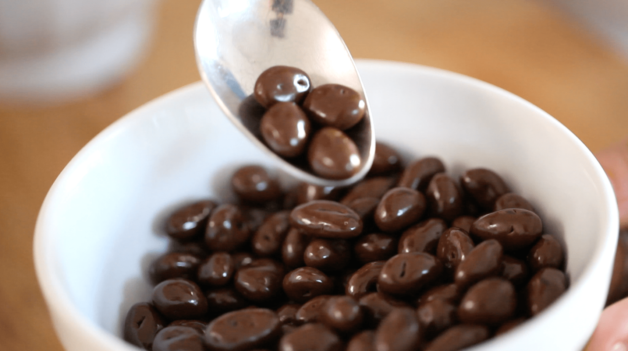 Bowl of chocolate covered raisins and spoon scooping them