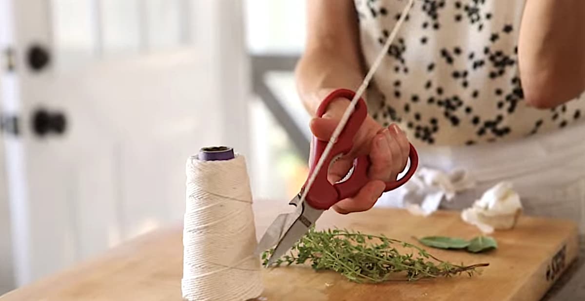 Cutting Butchers Twine to wrap up thyme bundle