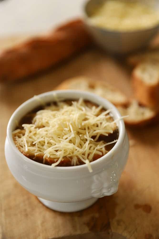 grated cheese on top of the bread in a French Soup Bowl.