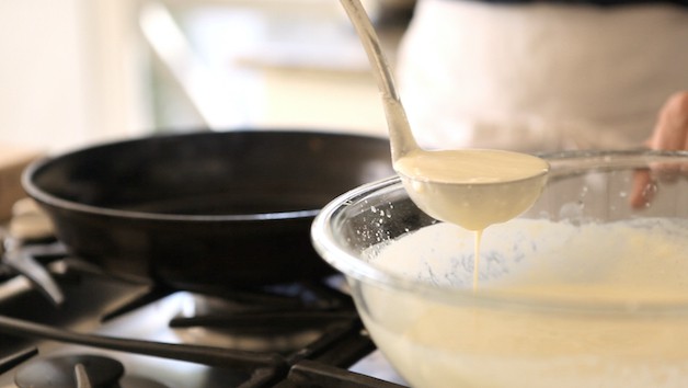 ladle filled with crepe batter
