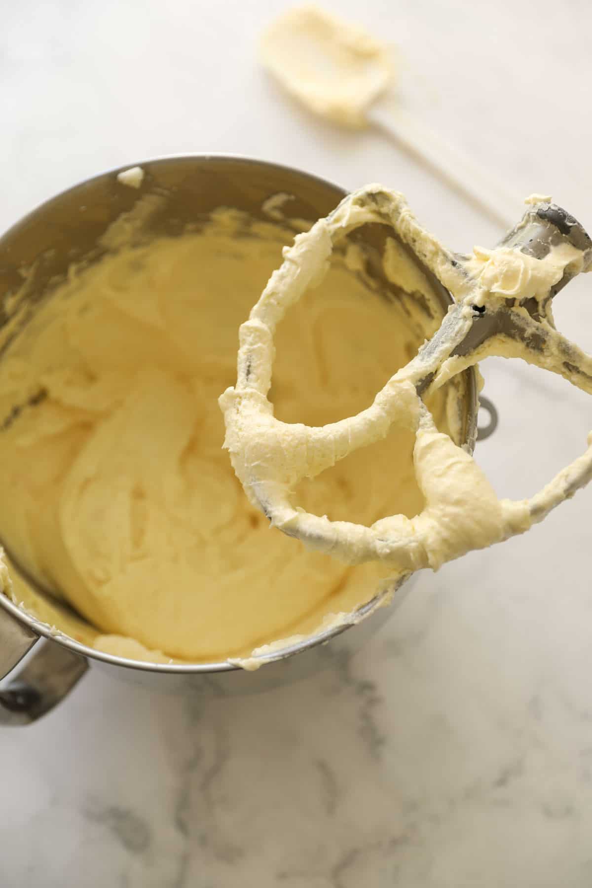 cake batter in a mixing bowl with a paddle attachment