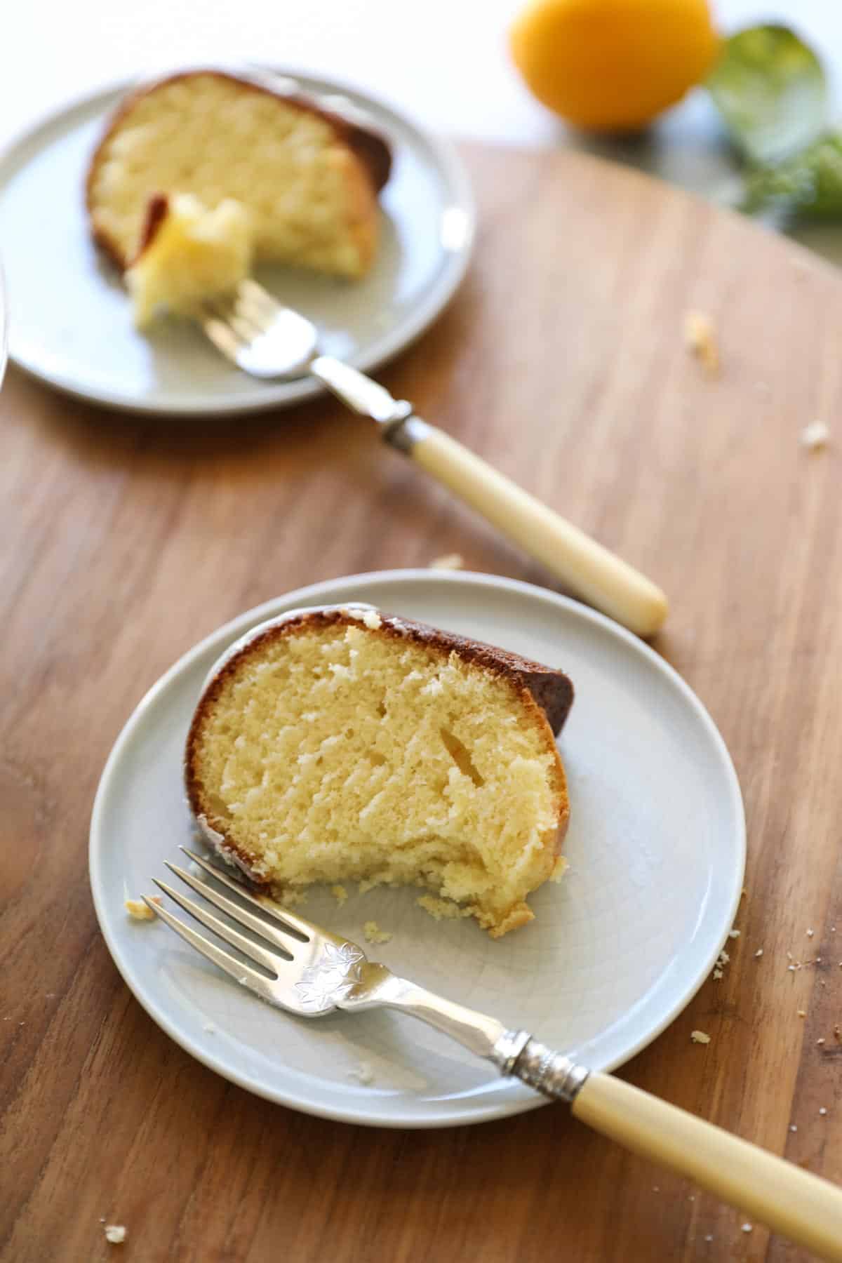 two slices of cake with forks on a cutting board