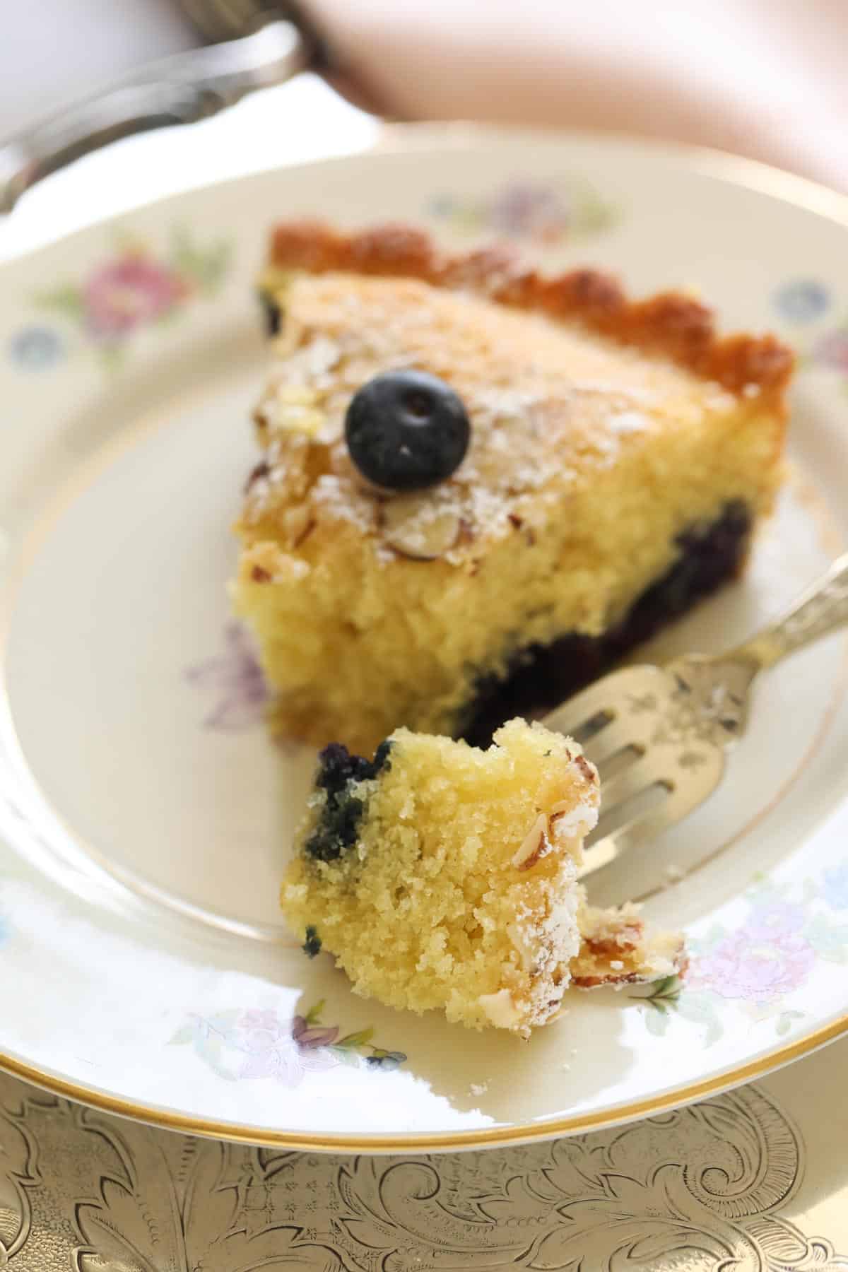 a fork taking a bite out of a slice of cake