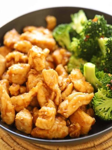 A bowl of stir fry chicken and broccoli