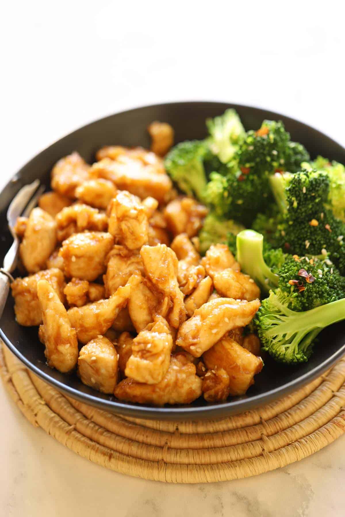a bowl of stir fried chicken and broccoli