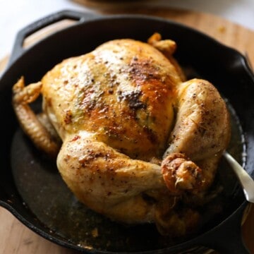 a roasted chicken in a cast iron skillet