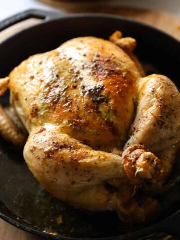 a roasted chicken in a cast iron skillet