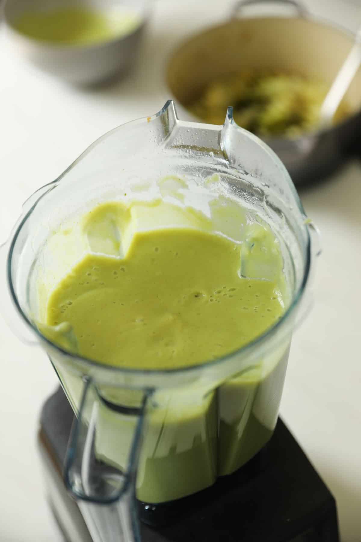 A Blender filled with soup already blended.