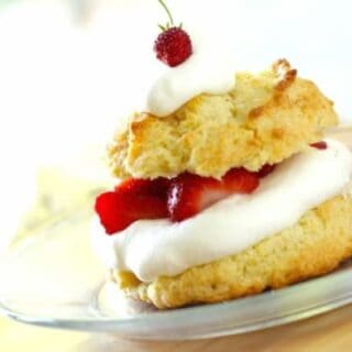 Strawberry Shortcake Biscuit on a plate with whippped cream and strawberries