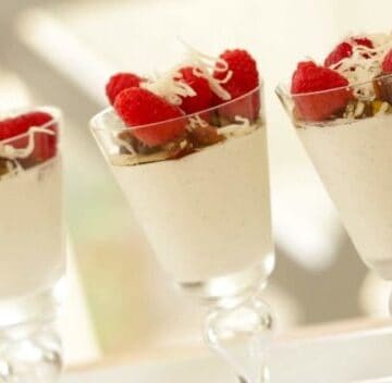 Greek Yogurt Panna Cotta served with fruit and nuts on top in tall glasses