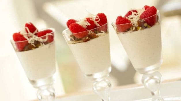 Greek Yogurt Panna Cotta served with fruit and nuts on top in tall glasses