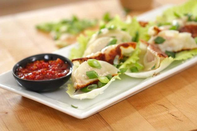 Homemade Potstickers on a plate with dipping sauce