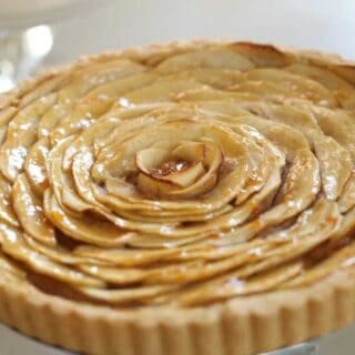 Freshly baked French Apple Tart on a glass cake stand