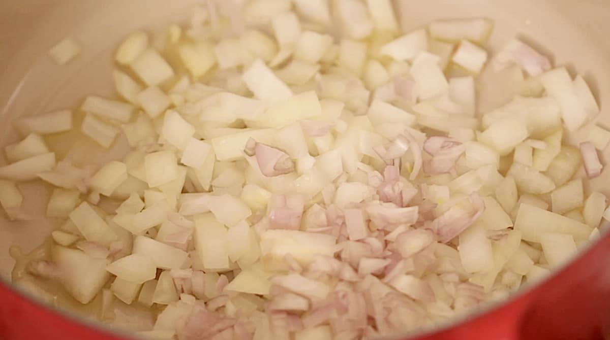 shallots and onions sauting in a large soup pot