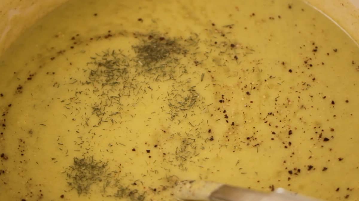 cream of broccoli soup with dried dill, salt and pepper floating on top