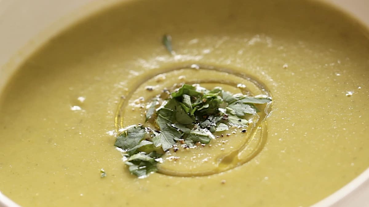 close up of chopped parsley on cream of broccoli soup