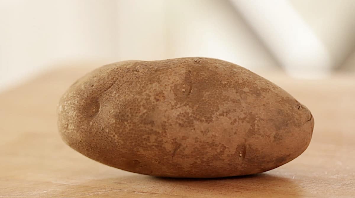 a russet potato on a board