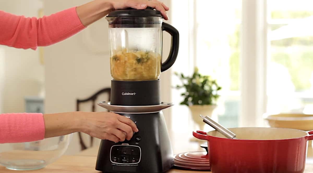 Blending vegetables and vegetable broth in a blender