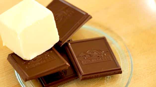 Bittersweet chocolate and butter in the bottom of a glass bowl