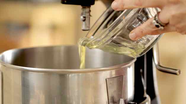 Adding Egg Whites in a glass bowl to a stand mixer