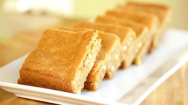baked and cut butterscotch blondie recipe served on a white plate