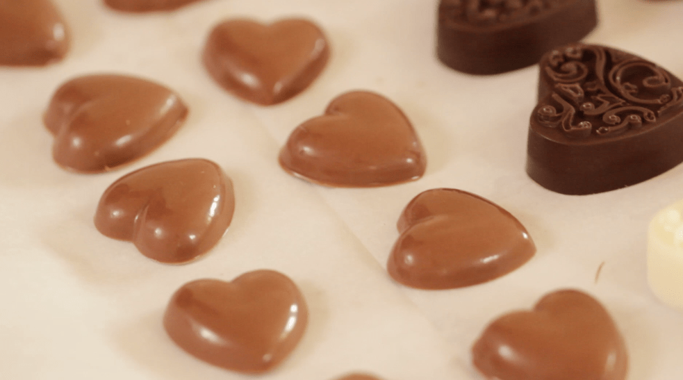 Homemade Chocolates setting up on parchment paper