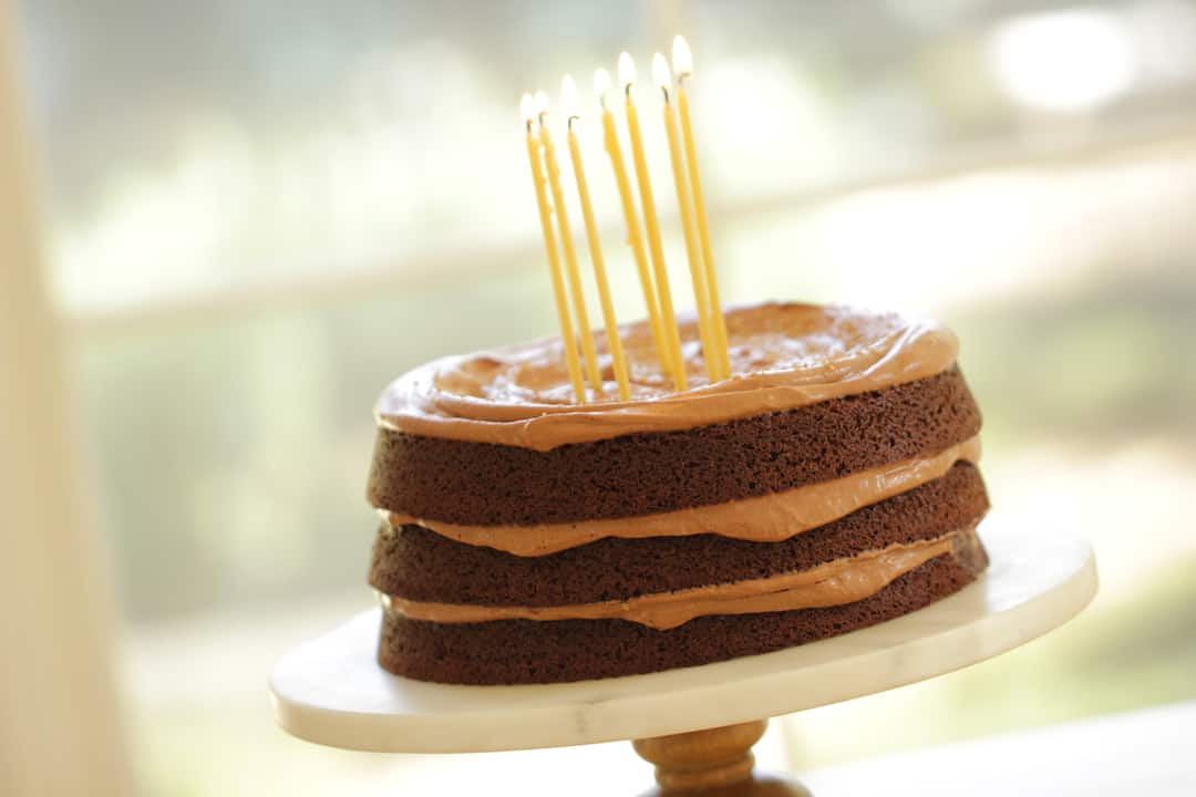 chocolate Birthday Cake Recipe on a marble cake stand with frosting