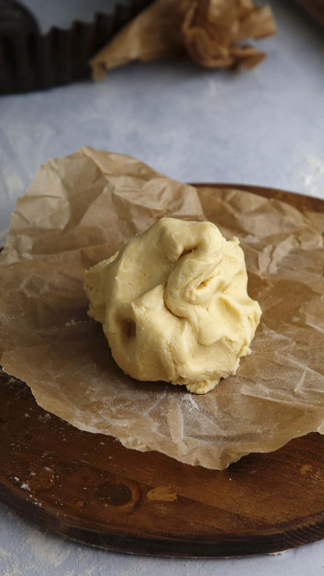 Homemade dough on parchment paper on a cutting board