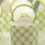 key lime cups served in a green cupcake liner with a wood blue spoon in