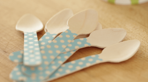 Blue wooden spoons spread out on a cutting board