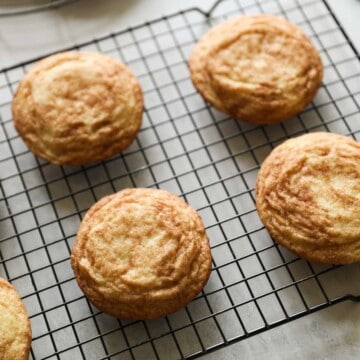 snickerdoodle cookies cooling on a rack