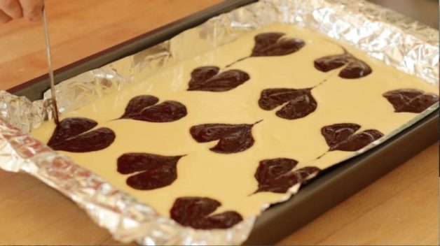 Cream Cheese Brownie batter in a foil-lined baking pan ready to go in the oven