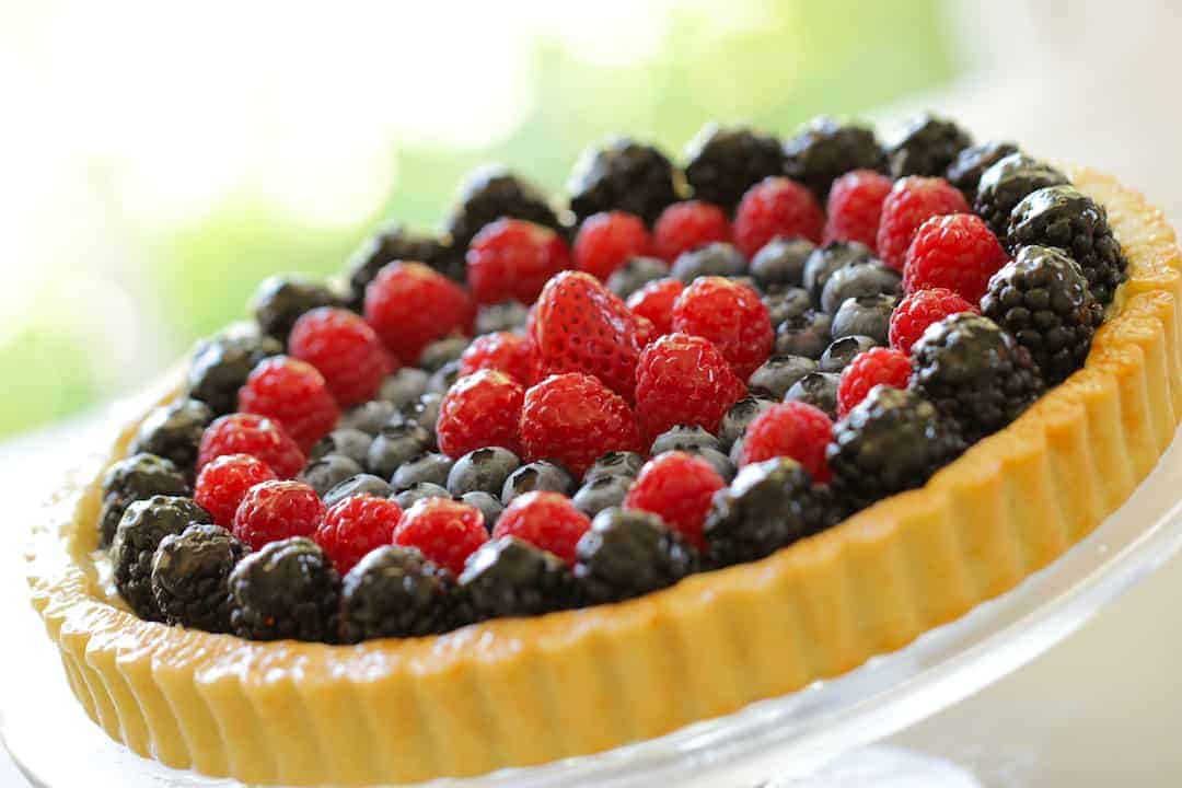 Red, White and Blue Fruit Tart on a glass cake stand