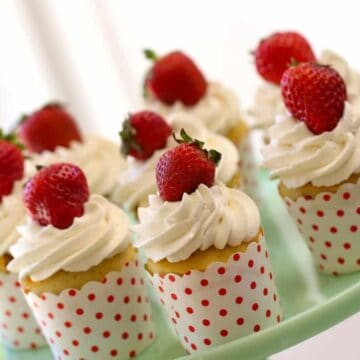 Easy Strawberry Shortcake Cupcakes recipe served on a green cake plate