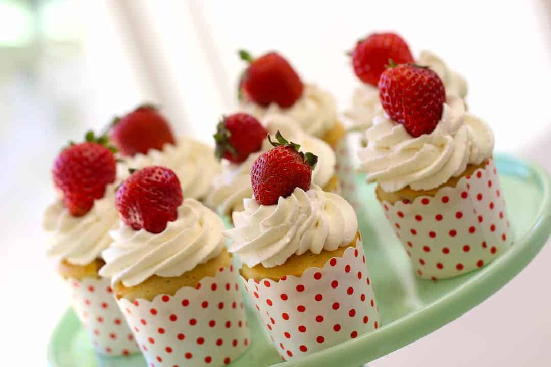 Strawberry Shortcake Cupcake Recipe in polka dot cups on green cake stand