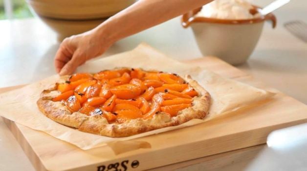 Apricot Galette on cutting board with whipped cream