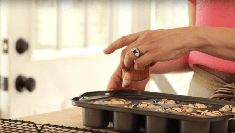 raspberry almond thimble cakes being released out of a mini cheesecake pan