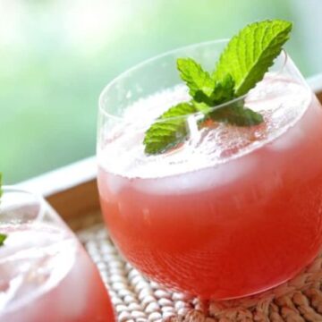 How to Make Watermelon Lemonade recipe served in a small glass with a fresh mint on top