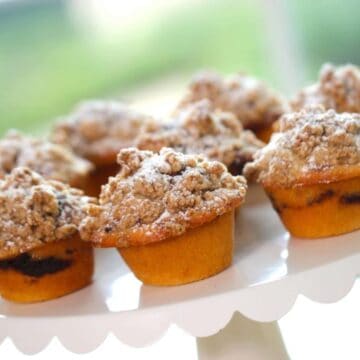 Coffee Cake Muffins served on a white scalloped cake stand
