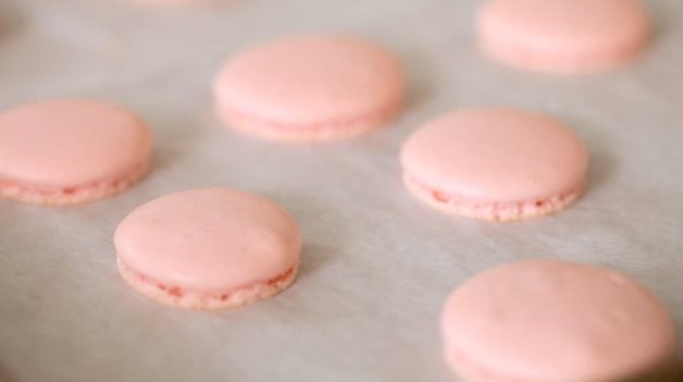 Macaron Shells with feet on a baking sheet