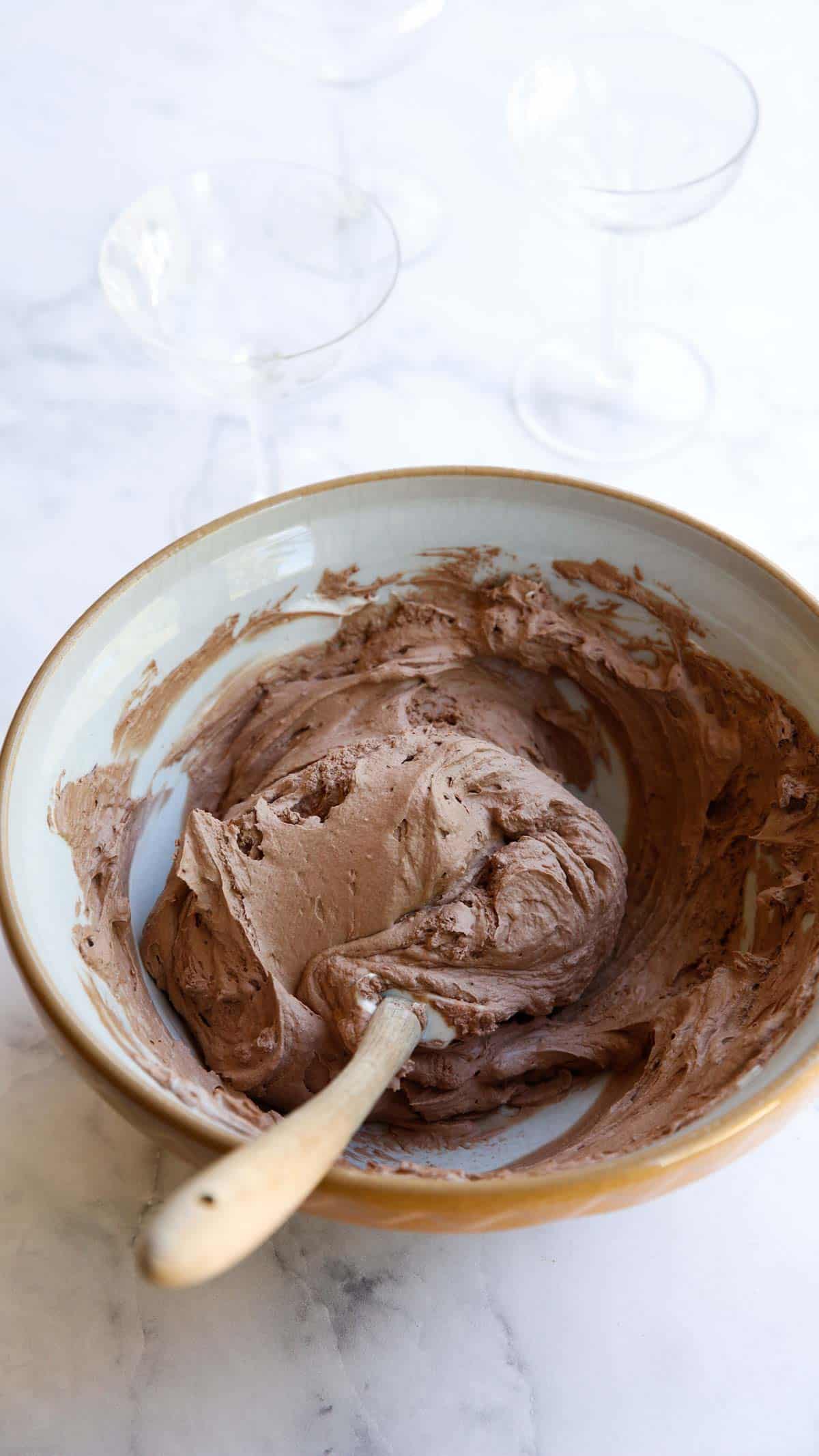 a bowl of chocolate mousse ready to be pipped into glasses