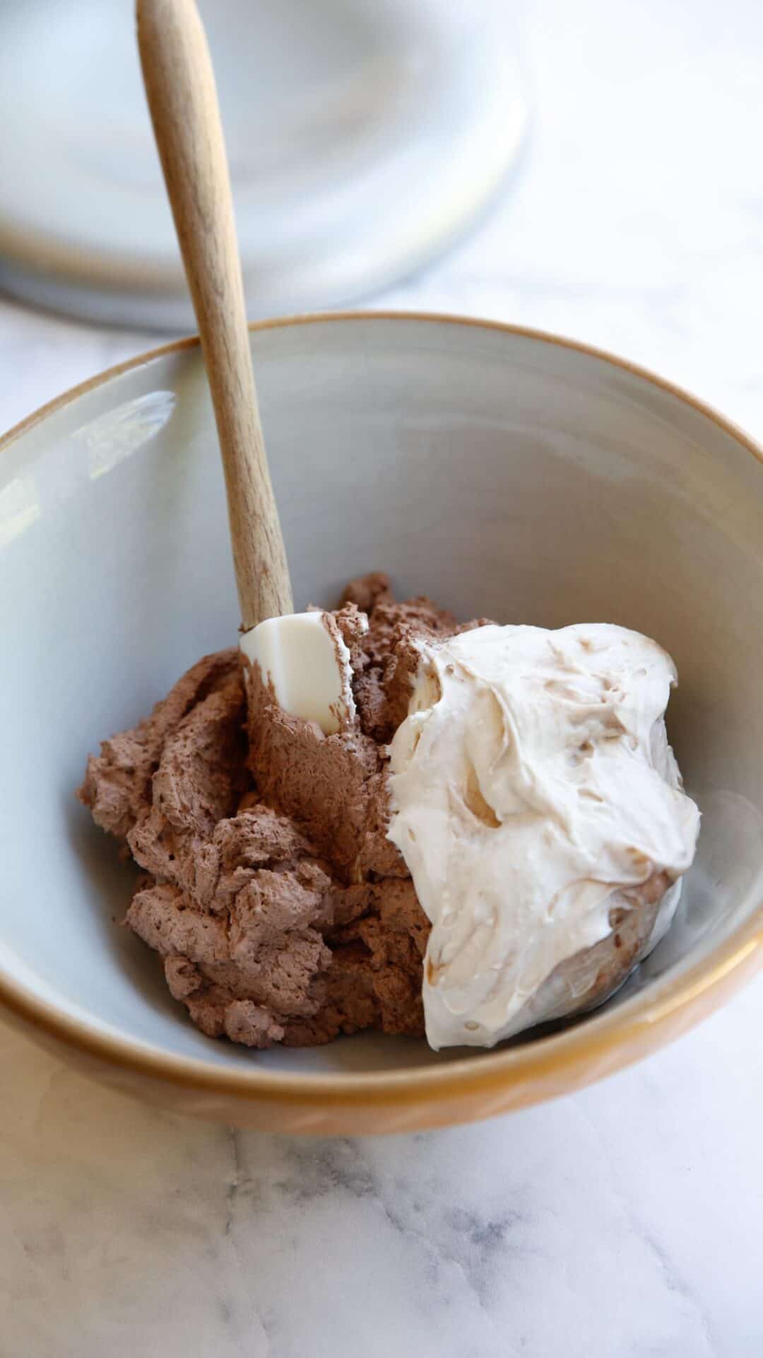 a bowl filled with chocolate whipped cream and sweetened cream cheese
