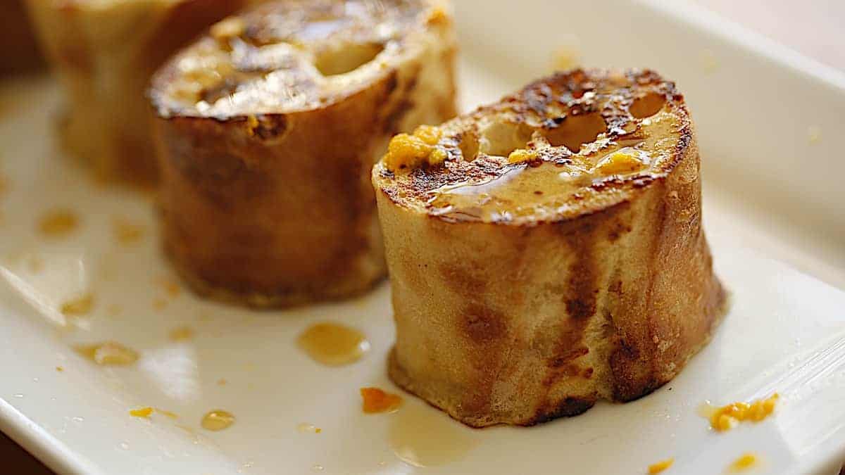 Two Baguette Slices on a white plate with syrup