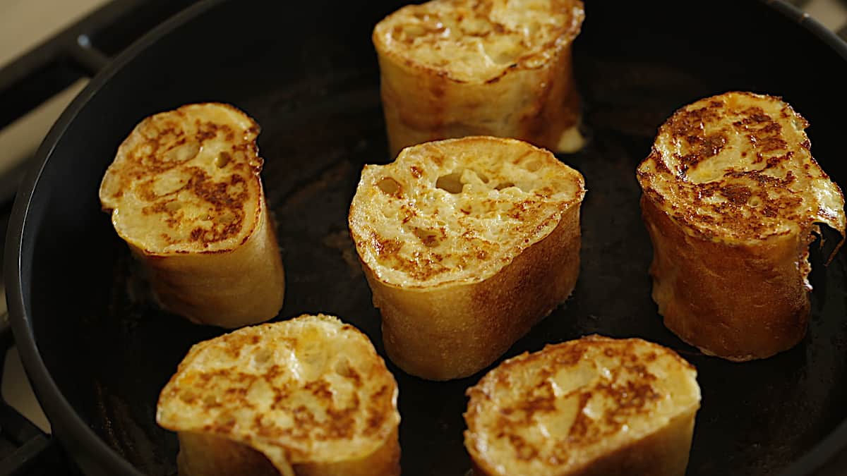 Baguette slices flipped in skillet toasted and golden brown