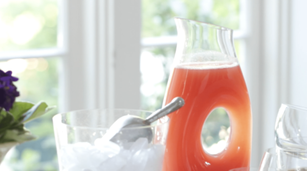 How to Make Watermelon Lemonade served in a clear pitcher with a bucket of ice on the side