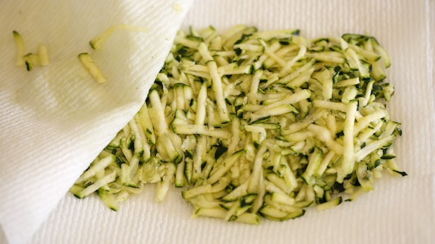 Grated zucchini between a paper towel