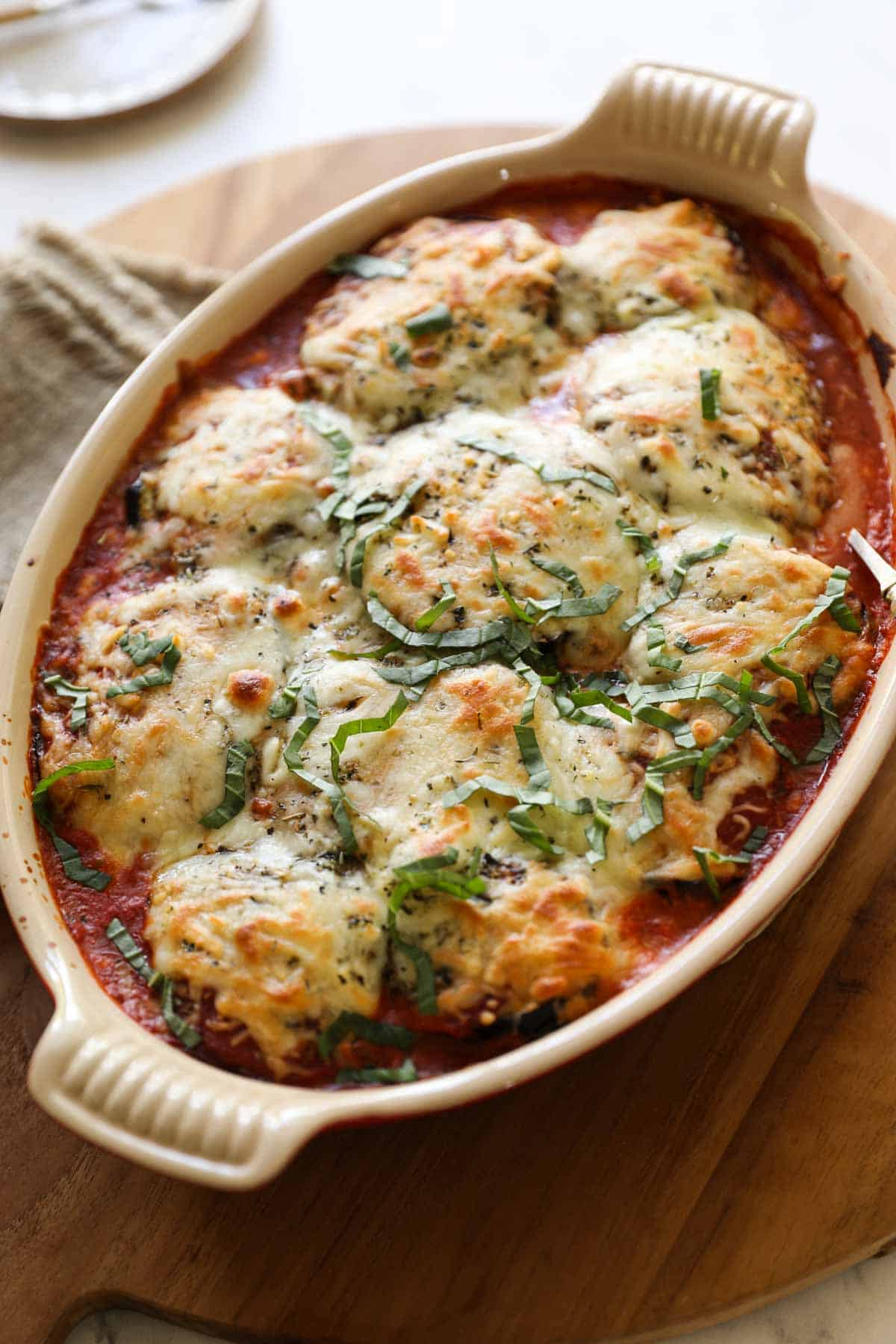baked eggplant lasagna in a red gratin pan